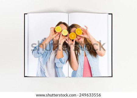 Girl playing with fruits printed on book