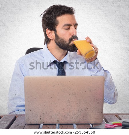 Businessman in his office drinking orange juice