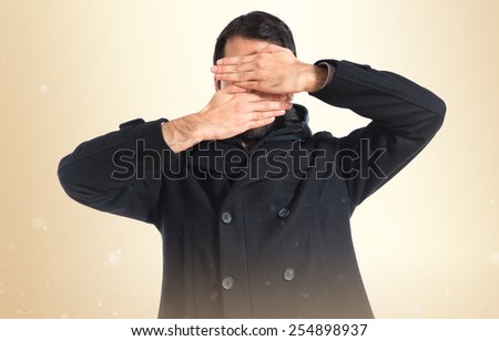 Man covering his face