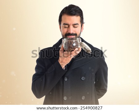 Man holding a jar glass with coffee inside