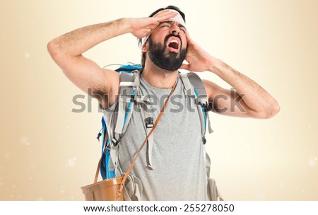 Adventurer with head injury over ocher background