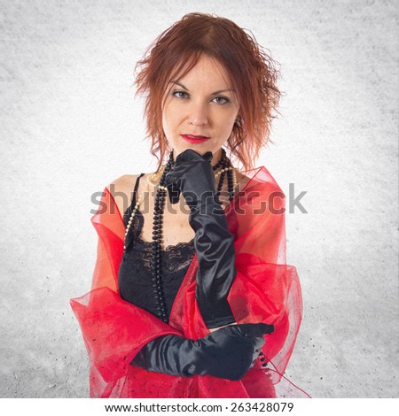 Woman in cabaret style thinking over textured background
