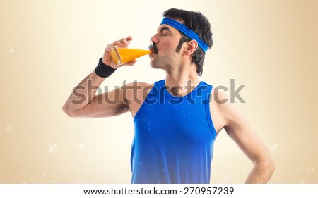 Vintage sportman drinking orange juice
