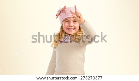 Little girl doing victory gesture