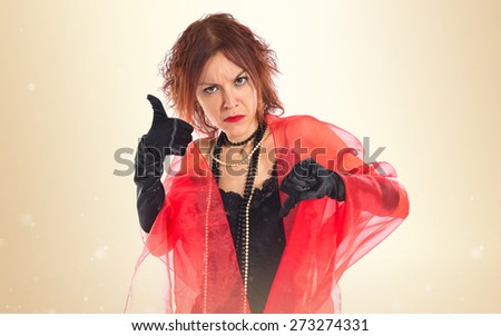 Woman in cabaret style making good-bad sign