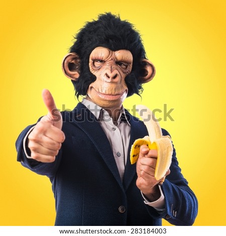 Monkey man eating a banana over colorful background