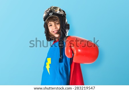 Girl dressed like superhero over colorful background