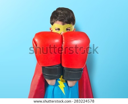 Child dressed like superhero over colorful background