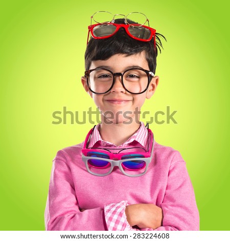 Happy boy with many glasses over colorful background