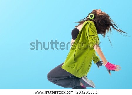 Teenager girl dancing street dance style over colorful background