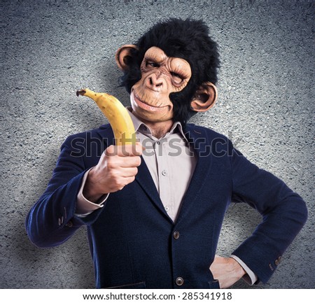 Monkey man holding a banana over textured background