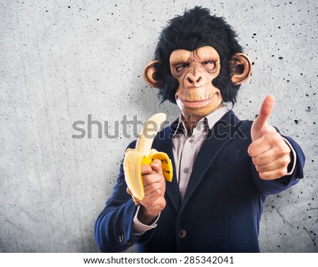 Monkey man eating a banana over textured background