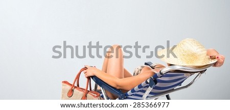 Woman resting on beach chair over textured background
