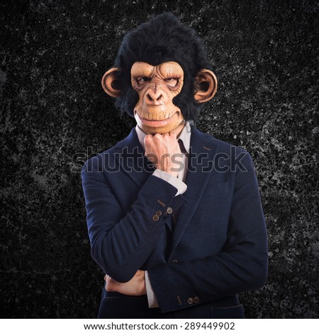 Monkey man thinking over textured background