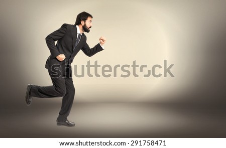Businessman running fast over textured background