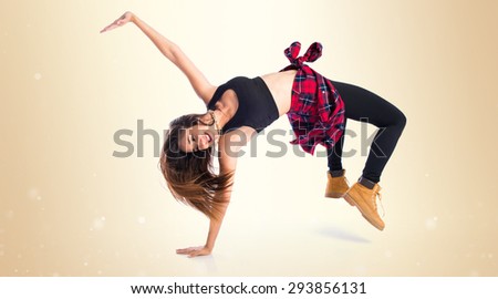 Girl dancing street dance over ocher background