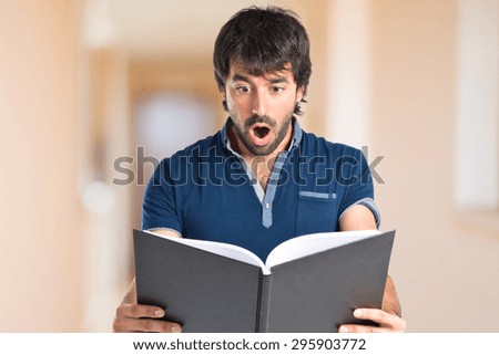 Man reading a book inside house