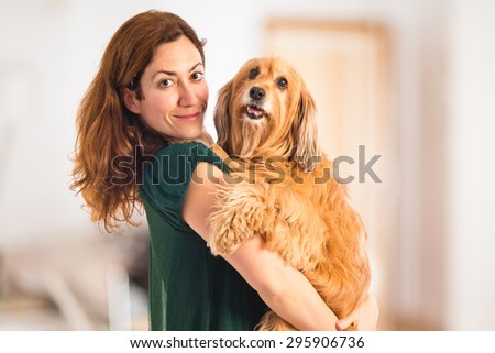Girl hugging her dog inside house
