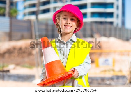 Blonde little girl dressed like workman on unfocused background