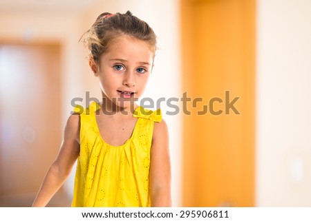 Blonde little girl walking inside house