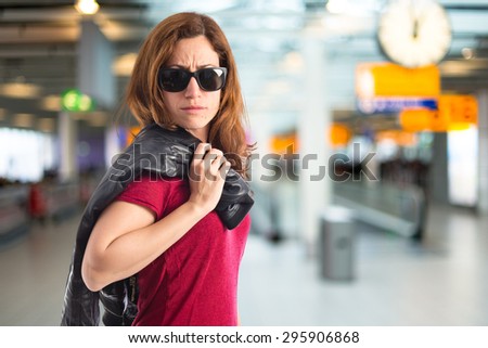 Rock woman with leather jacket on unfocused background