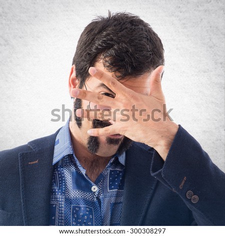Vintage young man covering his face