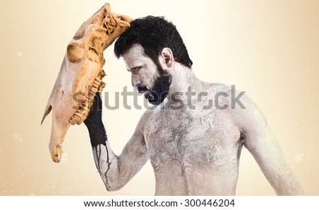 primitive man with horse skull like a mask