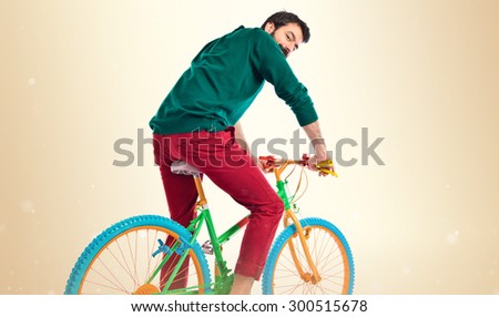 man on bike over ocher background