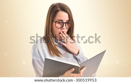 Surprised girl reading book