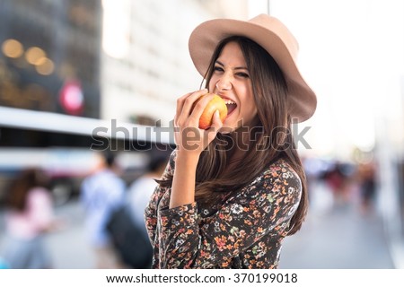 Pretty woman eating an apple