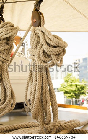 Ropes hanging from sails on a ship