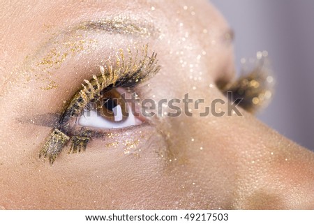 Fashion gold make-up, women eye close-up