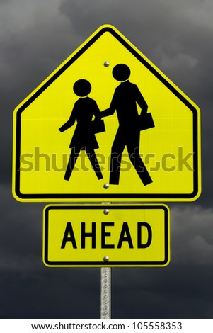 A yellow school zone ahead sign with post and screws and dark rain clouds