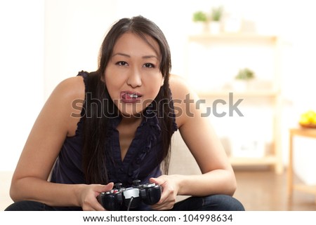 Cute girl gaming with tongue sticking out