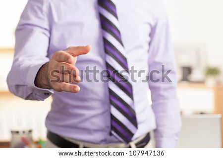 Detail of man extending hand for hand shake