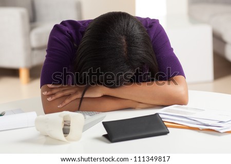stock-photo-attractive-young-african-american-woman-working-on-finances-at-home-wearing-purple-jacket-sitting-111349817.jpg