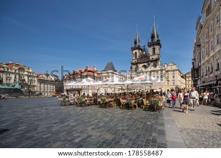 PRAGUE, CZECH REPUBLIC - JULY 28: Tourists visit the Old Town Square and Tyn Church of Prague on July 28, 2013. Prague\'s historic center is a UNESCO World Heritage Site.