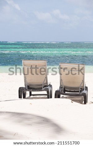 Two sunbeds on gold sand beach