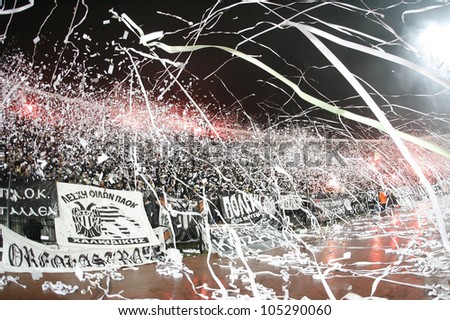 THESSALONIKI, GREECE - MAY 11: Fans and supporters of PAOK team in football match between Paok and Aris cheering for their team goals on May 11, 2010 in Thessaloniki, Greece.