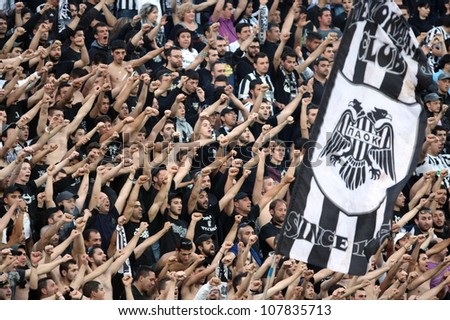 THESSALONIKI, GREECE - MARCH 16: Fans and supporters of PAOK team in football match between Paok and AEK cheering for their team goals on March 16, 2011 in Thessaloniki, Greece.