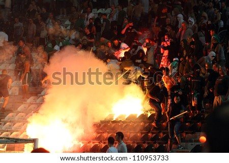 THESSALONIKI, GREECE-AUG 23:Clashes PAOK Thessaloniki and Rapid Vienna fans and the police before UEFA Europe League Playoff Football Match at Toumba Stadium on August 23, 2012 in Thessaloniki,Greece.