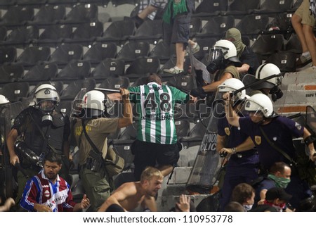 THESSALONIKI, GREECE-AUG 23:Clashes PAOK Thessaloniki and Rapid Vienna fans and the police before UEFA Europe League Playoff Football Match at Toumba Stadium on August 23, 2012 in Thessaloniki,Greece.