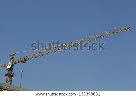 A lifting crane under blue sky