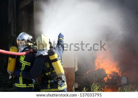 THESSALONIKI, GREECE - APRIL 19:Firefighter fighting for a fire attack, during a training exercise for the consequences earthquake in industrial area of Sindos on April 19,2013 in Thessaloniki, Greece
