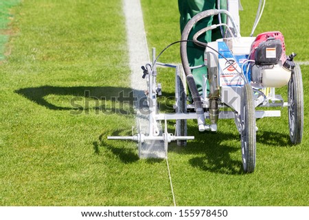 THESSALONIKI, GREECE - SEPT 19 : Painting lines and general prepares of the football field before the Europa League match Paok vs Shakhter Karagandy on September 19, 2013 in Thessaloniki, Greece.