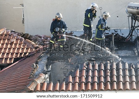 THESSALONIKI,GREECE-JAN 07: Firefighters try to extinguish the fire at a scorched floor flat in Thessaloniki on January 7, 2014. Three dead and two injured is the outcome of the fire that broke out.