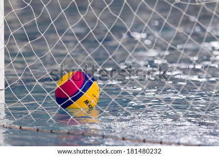 THESSALONIKI, GREECE MAR 5, 2014 : A water polo ball floating on the water in the net during the water polo game PAOK vs Nereas on March 5, 2014.