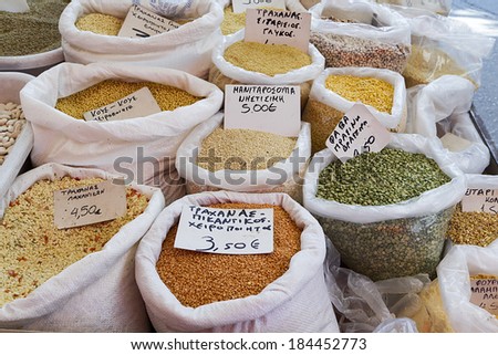 Close-up of bags of cereals in a local country fair with greek names and prices