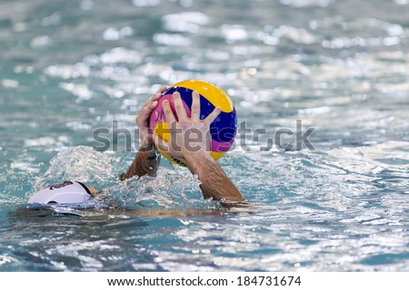 THESSALONIKI, GREECE MAR 22, 2014 : Close-up on a hand holding the water polo ball during the Greek League water polo game PAOK vs Vouliagmeni on March 22, 2014.