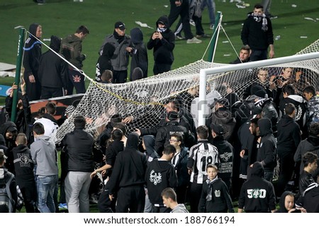 THESSALONIKI, GREECE APRIL 16, 2014 : Big crowd of fans getting in the field and getting the goal net after the Greek Cup Semi Final match PAOK vs Olympiacos